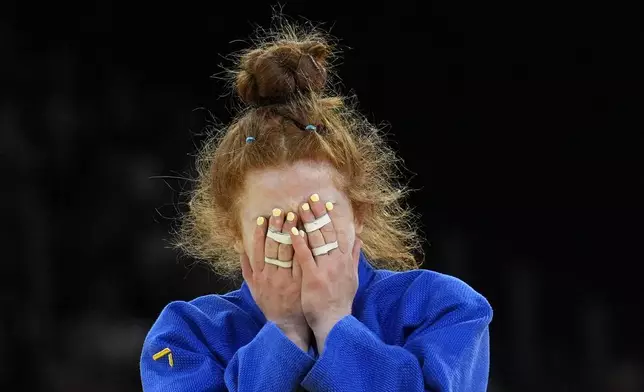 Austria's Lubjana Piovesana celebrates after defeating South Korea's Jisu Kim during their women -63 kg repechage match in team judo competition at Champ-de-Mars Arena during the 2024 Summer Olympics, Tuesday, July 30, 2024, in Paris, France. (AP Photo/Eugene Hoshiko)