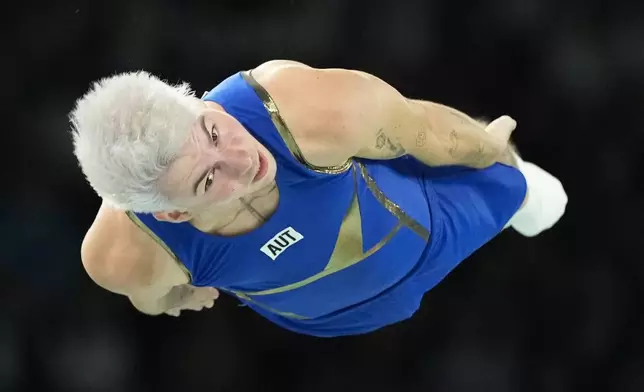 Benny Wizani of Austria competes during the men's trampoline qualifying round in Bercy Arena at the 2024 Summer Olympics, Friday, Aug. 2, 2024, in Paris, France. (AP Photo/Charlie Riedel)