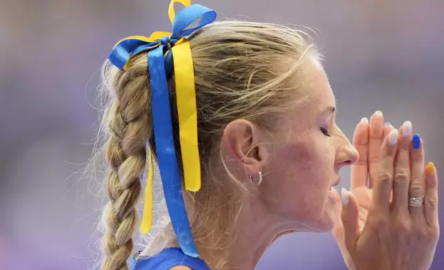 Anna Ryzhykova, of Ukraine, prepares to start in a women's 400 meters hurdles repechage round heat at the 2024 Summer Olympics, Monday, Aug. 5, 2024, in Saint-Denis, France. (AP Photo/Martin Meissner)