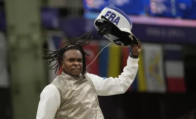 CORRECTS MATCH DETAILS France's Enzo Lefort celebrates after winning the men's team foil final match against China during the 2024 Summer Olympics at the Grand Palais, Sunday, Aug. 4, 2024, in Paris, France. (AP Photo/Christophe Ena)