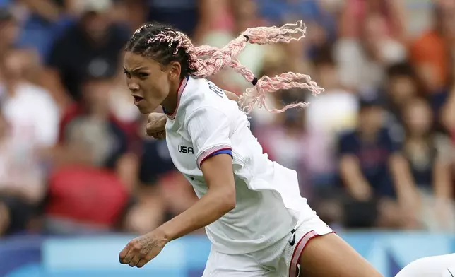 Trinity Rodman of the United States takes a shot during the quarterfinal women's soccer match between the United States and the Japan at the Parc des Princes at the 2024 Summer Olympics, Saturday, Aug. 3, 2024, in Paris, France. (AP Photo/Aurelien Morissard)