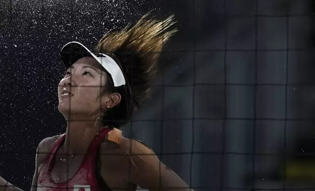 Japan's Miki Ishii eyes the ball during the women's pool E beach volleyball match between Netherlands and Japan at Eiffel Tower Stadium at the 2024 Summer Olympics, Tuesday, July 30, 2024, in Paris, France. (AP Photo/Louise Delmotte)