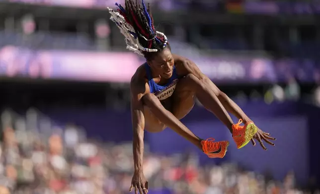 Tori Franklin, of the United States, makes an attempt in the women's triple jump qualification at the 2024 Summer Olympics, Friday, Aug. 2, 2024, in Saint-Denis, France. (AP Photo/Bernat Armangue)