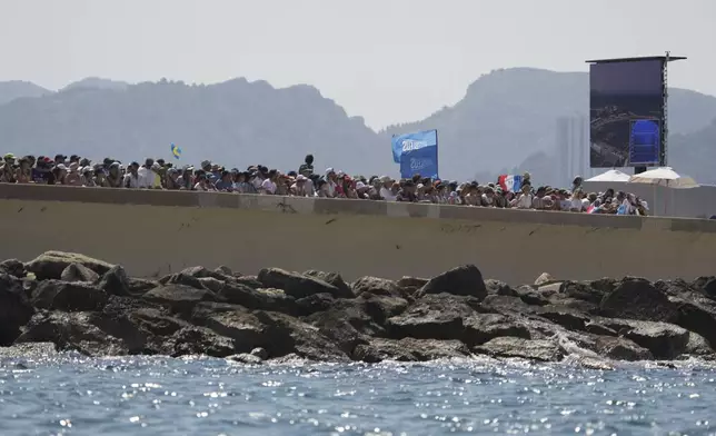 Spectators watch a women's skiff race, at the 2024 Summer Olympics, Friday, Aug. 2, 2024, in Marseille, France. (AP Photo/Jacquelyn Martin)