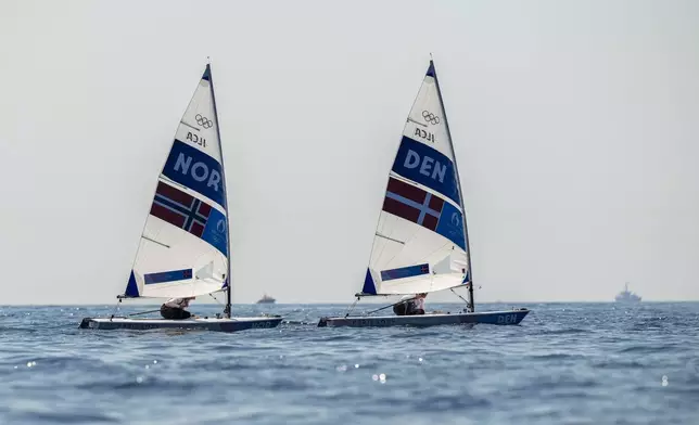 Anne-Marie Rindom of Denmark, right, and Line Flem Hoest of Norway sail back to the harbour after ILCA 6 dinghy class final race was postponed during the 2024 Summer Olympics, Tuesday, Aug. 6, 2024, in Marseille, France. (AP Photo/Carolyn Kaster)