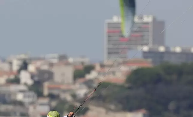 Valentin Bontus of Austria celebrates after the men's kite semifinal race during the 2024 Summer Olympics, Thursday, Aug. 8, 2024, in Marseille, France. (AP Photo/Carolyn Kaster)