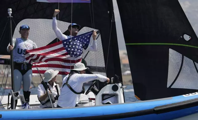 Ian Barrows and Hans Henken of the United States celebrate clinching the bronze medal in the men's skiff race, at the 2024 Summer Olympics, Friday, Aug. 2, 2024, in Marseille, France. (AP Photo/Jacquelyn Martin)