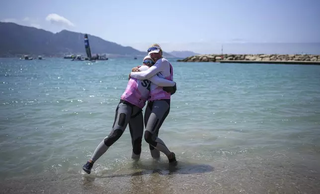 Vilma Bobeck, right, and Rebecca Netzler of Sweden celebrate winning the silver medal in the women's skiff race at the Olympic marina during the 2024 Summer Olympics, Friday, Aug. 2, 2024, in Marseille, France. (AP Photo/Daniel Cole)