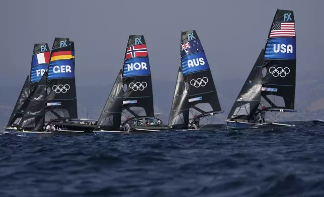 Boats start a women's skiff race, at the 2024 Summer Olympics, Friday, Aug. 2, 2024, in Marseille, France. (AP Photo/Jacquelyn Martin)