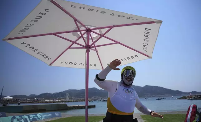 Valentin Bontus of Austria dances during a delay before the men's kite semifinal race during the 2024 Summer Olympics, Thursday, Aug. 8, 2024, in Marseille, France. (AP Photo/Daniel Cole)