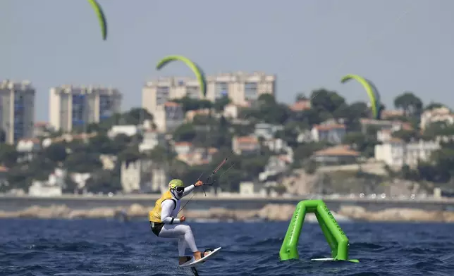 Valentin Bontus of Austria celebrates after the men's kite semifinal race during the 2024 Summer Olympics, Thursday, Aug. 8, 2024, in Marseille, France. (AP Photo/Carolyn Kaster)