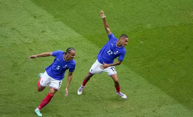 France's Enzo Millot, right, and France's Kiliann Sildillia, left, celebrate after scoring during the men's soccer gold medal match between France and Spain at the Parc des Princes during the 2024 Summer Olympics, Friday, Aug. 9, 2024, in Paris, France. (AP Photo/Vadim Ghirda)