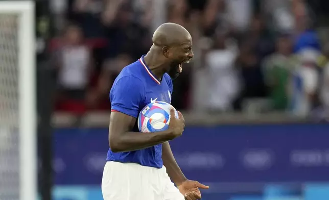 France's Jean-Philippe Mateta celebrates after scoring his team's third goal during the men's soccer gold medal match between France and Spain at the Parc des Princes during the 2024 Summer Olympics, Friday, Aug. 9, 2024, in Paris, France. (AP Photo/Francisco Seco)