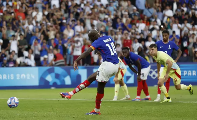 France's Jean-Philippe Mateta scores the third goal against Spain during the men's soccer gold medal match between France and Spain at the Parc des Princes during the 2024 Summer Olympics, Friday, Aug. 9, 2024, in Paris, France. (AP Photo/Aurelien Morissard)