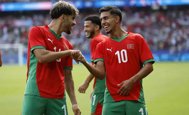 Morocco's Ilias Akhomach, right, celebrates scoring his side's second goal during the quarterfinal men's soccer match between Morocco and the United States at the Parc des Princes during the 2024 Summer Olympics, Friday, Aug. 2, 2024, in Paris, France. (AP Photo/Aurelien Morissard)