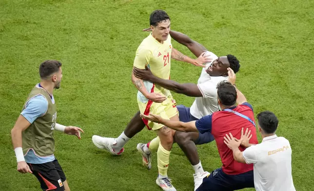 Spain's Sergio Camello, center, celebrates with teammates after scoring his side's fourth goal during the men's soccer gold medal match between France and Spain at the Parc des Princes during the 2024 Summer Olympics, Friday, Aug. 9, 2024, in Paris, France. (AP Photo/Vadim Ghirda)