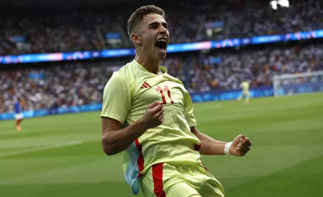 Spain's Fermin Lopez celebrates after scoring his goal during the men's soccer gold medal match between France and Spain at the Parc des Princes during the 2024 Summer Olympics, Friday, Aug. 9, 2024, in Paris, France. (AP Photo/Aurelien Morissard)