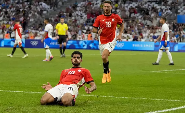 Egypt's Ibrahim Adel (10) reacts after scoring his side's first goal during a men's quarterfinal soccer match between Egypt and Paraguay at the 2024 Summer Olympics, Friday, Aug. 2, 2024, at Marseille Stadium in Marseille, France. (AP Photo/Julio Cortez)