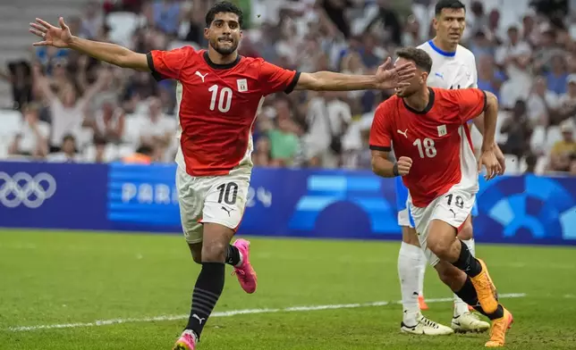 Egypt's Ibrahim Adel (10) reacts after scoring his side's first goal during a men's quarterfinal soccer match between Egypt and Paraguay at the 2024 Summer Olympics, Friday, Aug. 2, 2024, at Marseille Stadium in Marseille, France. (AP Photo/Julio Cortez)