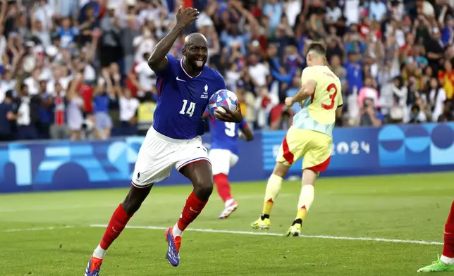 France's Jean-Philippe Mateta celebrates after scoring the third goal against Spain during the men's soccer gold medal match between France and Spain at the Parc des Princes during the 2024 Summer Olympics, Friday, Aug. 9, 2024, in Paris, France. (AP Photo/Aurelien Morissard)