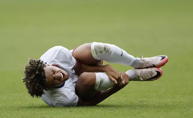 Kevin Paredes of the United States reacts after being tackled during the quarterfinal men's soccer match between Morocco and the United States at the Parc des Princes during the 2024 Summer Olympics, Friday, Aug. 2, 2024, in Paris, France. (AP Photo/Aurelien Morissard)