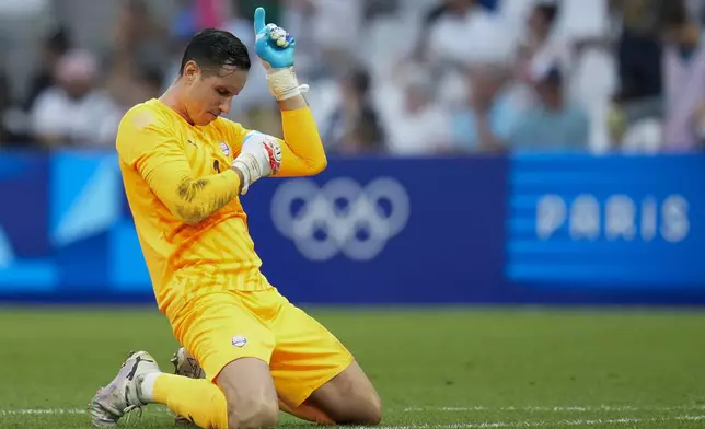 Paraguay goalkeeper Gatito Fernandez reacts after teammate Diego Gomez scored their side's first goal during a men's quarterfinal soccer match between Egypt and Paraguay at the 2024 Summer Olympics, Friday, Aug. 2, 2024, at Marseille Stadium in Marseille, France. (AP Photo/Julio Cortez)