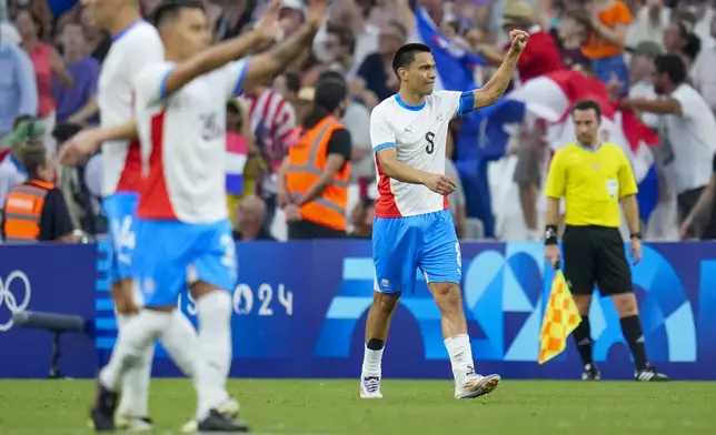 Paraguay's Diego Gomez (8) gestures after scoring his side's first goal during a men's quarterfinal soccer match between Egypt and Paraguay at the 2024 Summer Olympics, Friday, Aug. 2, 2024, at Marseille Stadium in Marseille, France. (AP Photo/Julio Cortez)