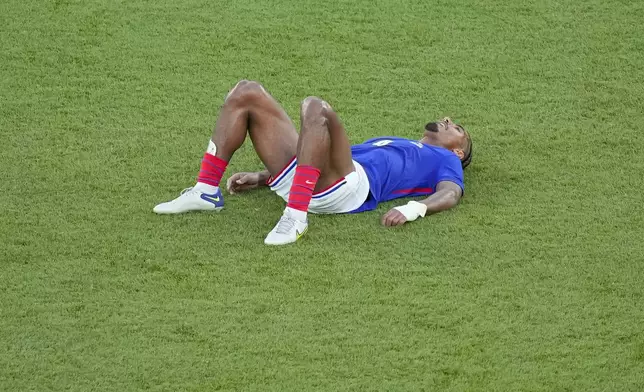 France's Loic Bade is dejected at the end of the men's soccer gold medal match between France and Spain at the Parc des Princes during the 2024 Summer Olympics, Friday, Aug. 9, 2024, in Paris, France. (AP Photo/Vadim Ghirda)