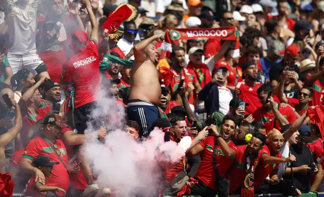 Morocco supporters celebrate after Soufiane Rahimi scored the opening goal from the penalty spot during the quarterfinal men's soccer match between Morocco and the United States at the Parc des Princes during the 2024 Summer Olympics, Friday, Aug. 2, 2024, in Paris, France. (AP Photo/Aurelien Morissard)