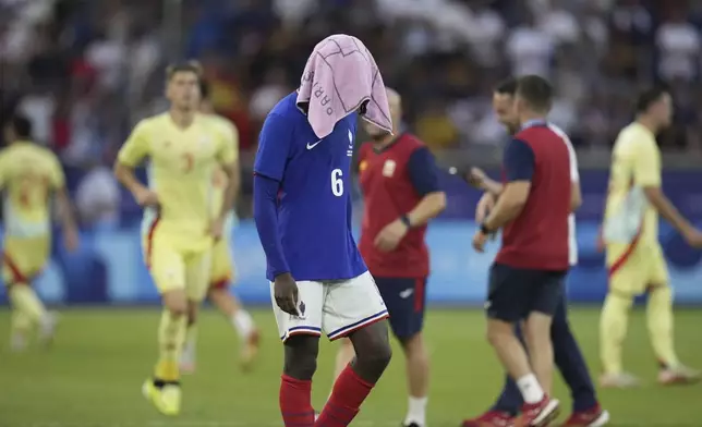 France's Manu Kone reacts after losing the men's soccer gold medal match against Spain at the Parc des Princes during the 2024 Summer Olympics, Friday, Aug. 9, 2024, in Paris, France. (AP Photo/Francisco Seco)