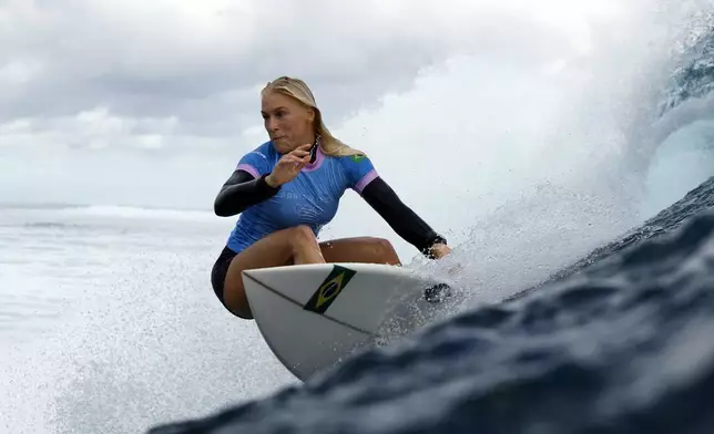 Tatiana Weston-Webb, of Brazil, drops into a wave in the women's gold medal final in the surfing competition during the Paris 2024 Olympic Games in Teahupo'o, Tahiti, Monday, Aug. 5, 2024. (Ben Thouard/Pool Photo via AP)