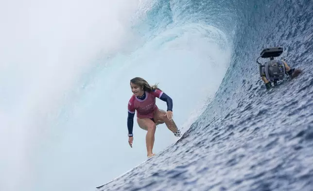 Caroline Marks, of the United States, surfs during the gold medal match of the surfing competition at the 2024 Summer Olympics, Monday, Aug. 5, 2024, in Teahupo'o, Tahiti. (AP Photo/Gregory Bull)