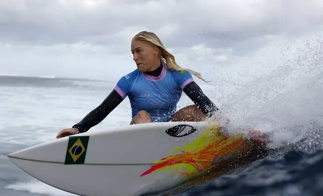 Tatiana Weston-Webb, of Brazil, carves off a wave in the women's gold medal final in the surfing competition during the Paris 2024 Olympic Games in Teahupo'o, Tahiti, Monday, Aug. 5, 2024. (Ben Thouard/Pool Photo via AP)