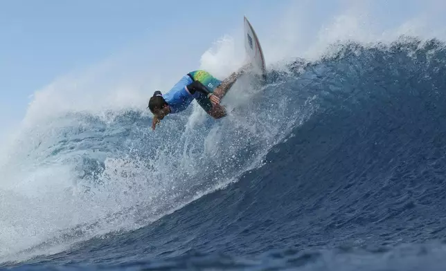 Jack Robinson, of Australia, snaps off the lip during the semifinals of the surfing competition at the 2024 Summer Olympics, Monday, Aug. 5, 2024, in Teahupo'o, Tahiti. (Ben Thouard/Pool Photo via AP)