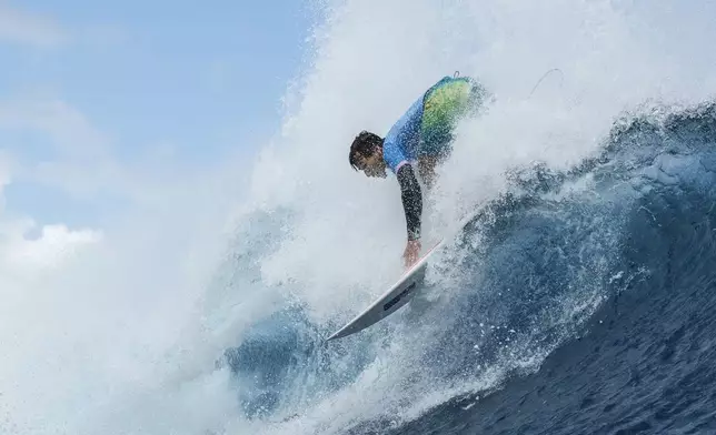 Jack Robinson, of Australia, snaps off the lip during the semifinals of the surfing competition at the 2024 Summer Olympics, Monday, Aug. 5, 2024, in Teahupo'o, Tahiti. (Ben Thouard/Pool Photo via AP)