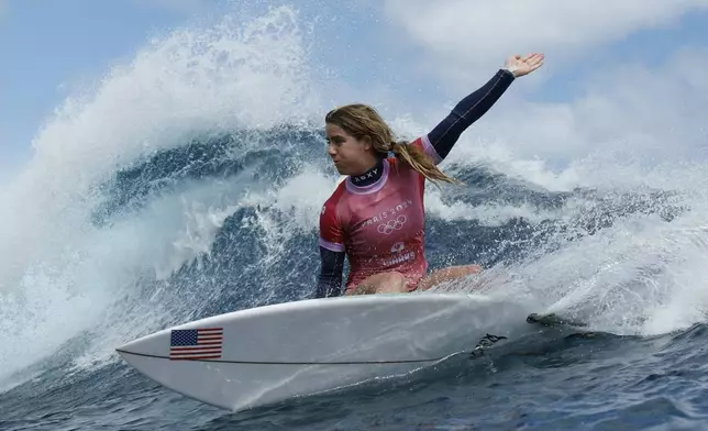 Caroline Marks, of the United States, turns on a wave in the semifinals of the surfing competition at the 2024 Summer Olympics, Monday, Aug. 5, 2024, in Teahupo'o, Tahiti. (Ben Thouard/Pool Photo via AP)