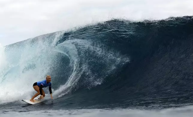 Tatiana Weston-Webb, of Brazil, drops into a wave in the women's gold medal final in the surfing competition during the Paris 2024 Olympic Games in Teahupo'o, Tahiti, Monday, Aug. 5, 2024. (Ben Thouard/Pool Photo via AP)