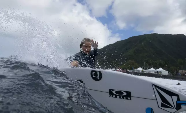 Kelia Gallina, 11, surfs her home shore break during a break in the 2024 Summer Olympics surfing competition, Wednesday, July 31, 2024, in Teahupo'o, Tahiti. While Teahupo'o has been a coveted destination for surfers from around the world for decades, it's only in more recent years that local surf culture and talent has begun to develop across Tahiti. (AP Photo/Gregory Bull)