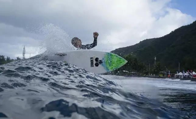 Tauirai Henriou Oopa, 10, surfs his home shore break during a break in the 2024 Summer Olympics surfing competition, Wednesday, July 31, 2024, in Teahupo'o, Tahiti. While Teahupo'o has been a coveted destination for surfers from around the world for decades, it's only in more recent years that local surf culture and talent has begun to develop across Tahiti. (AP Photo/Gregory Bull)