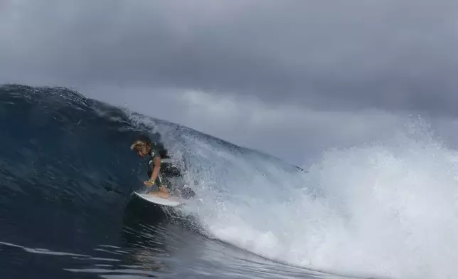 Liam Sham Koua, 11, surfs his home shore break during a break in the 2024 Summer Olympics surfing competition, Wednesday, July 31, 2024, in Teahupo'o, Tahiti. While Teahupo'o has been a coveted destination for surfers from around the world for decades, it's only in more recent years that local surf culture and talent has begun to develop across Tahiti. (AP Photo/Gregory Bull)