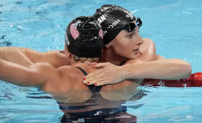 Summer McIntosh, right, of Canada, is congratulated buy Regan Smith, of the United States, after winning the women's 200-meter butterfly final at the 2024 Summer Olympics, Thursday, Aug. 1, 2024, in Nanterre, France. (AP Photo/Tsvangirayi Mukwazhi)