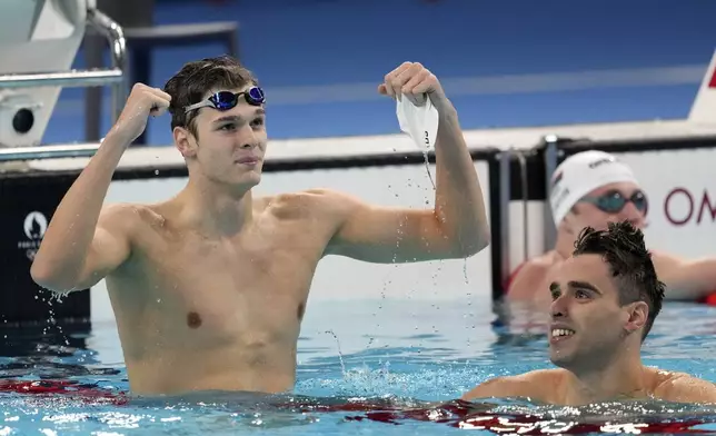 Hubert Kos, of Hungary, celebrates winning the men's 200-meter backstroke final at the 2024 Summer Olympics in Nanterre, France, Thursday, Aug. 1, 2024. (AP Photo/Ashley Landis)