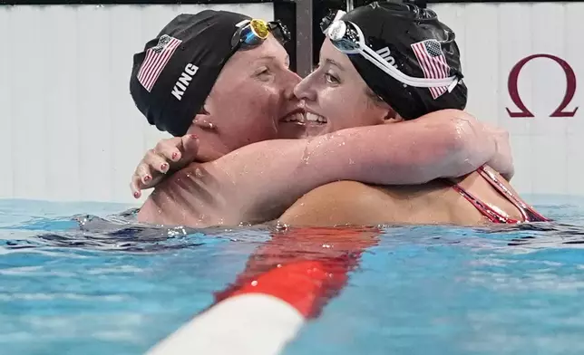 Kate Douglass, right, of the United States, is congratulated by teammate Lilly King after winning the women's 200-meter breaststroke final at the 2024 Summer Olympics, Thursday, Aug. 1, 2024, in Nanterre, France. (AP Photo/Matthias Schrader)