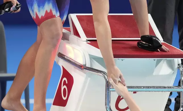 Katie Ledecky, of the United States, left, greets teammate Erin Gemmell at the end of the women's 4x200-meter freestyle relay final at the 2024 Summer Olympics in Nanterre, France, Thursday, Aug. 1, 2024. (AP Photo/Ashley Landis)