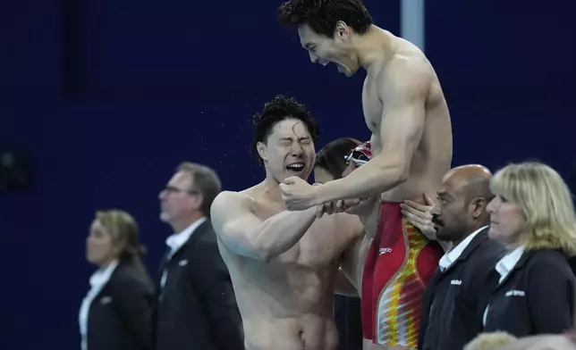 China's team celebrates winning the gold medal in the men's 4x100-meter medley relay final at the Summer Olympics in Nanterre, France, Sunday, Aug. 4, 2024. (AP Photo/Tsvangirayi Mukwazhi)