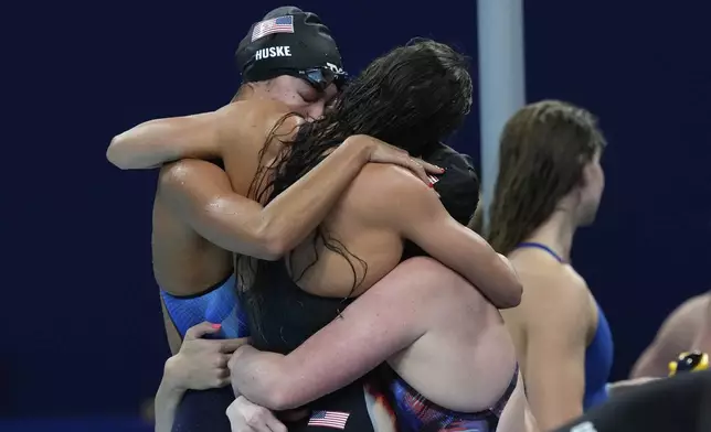 United States' Torri Huske embraces teammates after winning the gold medal in the women's 4x100-meter medley relay final at the Summer Olympics in Nanterre, France, Sunday, Aug. 4, 2024. (AP Photo/Tsvangirayi Mukwazhi)