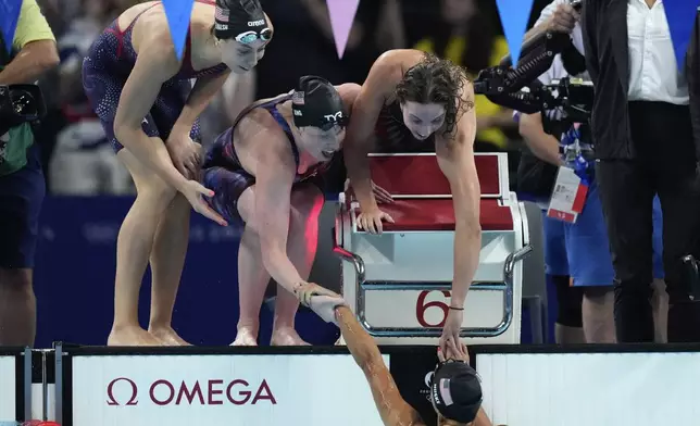 United States' Gretchen Walsh, from left, Lilly King, Regan Smith and Torri Huske celebrate winning the gold medal in the women's 4x100-meter medley relay final at the Summer Olympics in Nanterre, France, Sunday, Aug. 4, 2024. (AP Photo/Natacha Pisarenko)