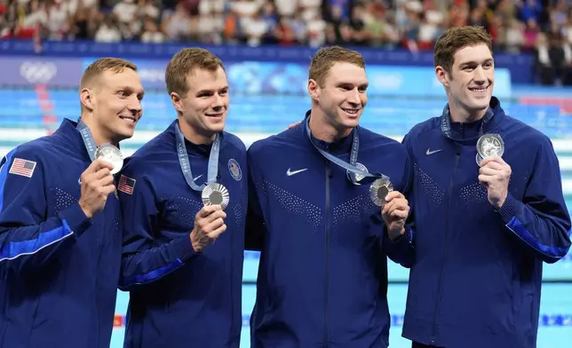 United States' Ryan Murphy, Nic Fink, Caeleb Dressel, and Hunter Armstrong pose for a phztowith their silver medals during the awards ceremony for the men's 4x100-meter medley relay at the Summer Olympics in Nanterre, France, Sunday, Aug. 4, 2024. (AP Photo/Brynn Anderson)