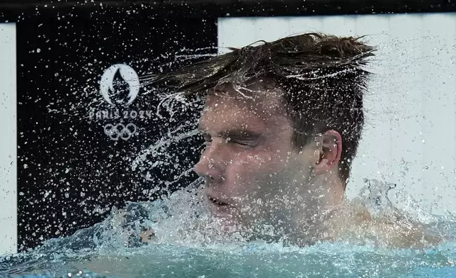 United States' Bobby Finke celebrates winning the gold medal in the men's 1500-meter freestyle final at the Summer Olympics in Nanterre, France, Sunday, Aug. 4, 2024.(AP Photo/Brynn Anderson)