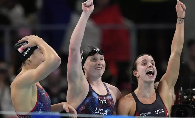 United States' Gretchen Walsh, from left, Lilly King and Regan Smith celebrate winning the gold medal in the women's 4x100-meter medley relay final at the Summer Olympics in Nanterre, France, Sunday, Aug. 4, 2024.(AP Photo/Brynn Anderson)